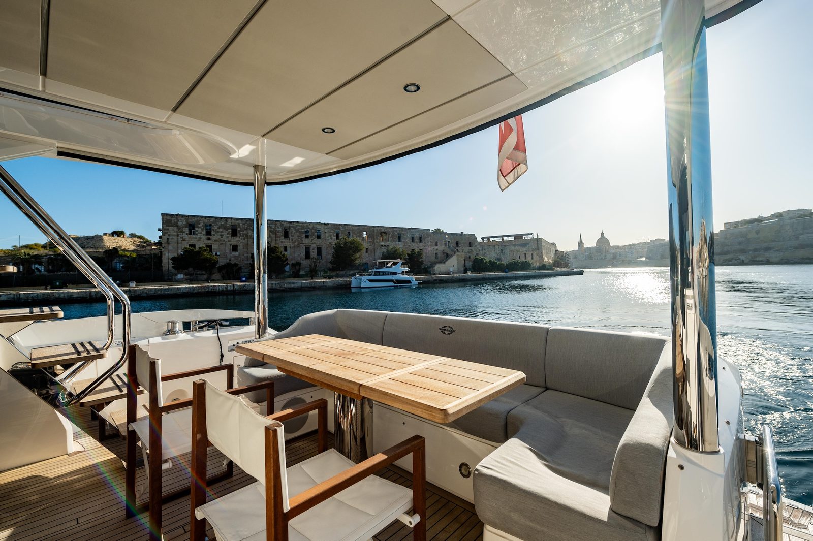 Shaded aft deck of the Sunseeker Manhattan 66 AQUANAUT at golden hour in Malta