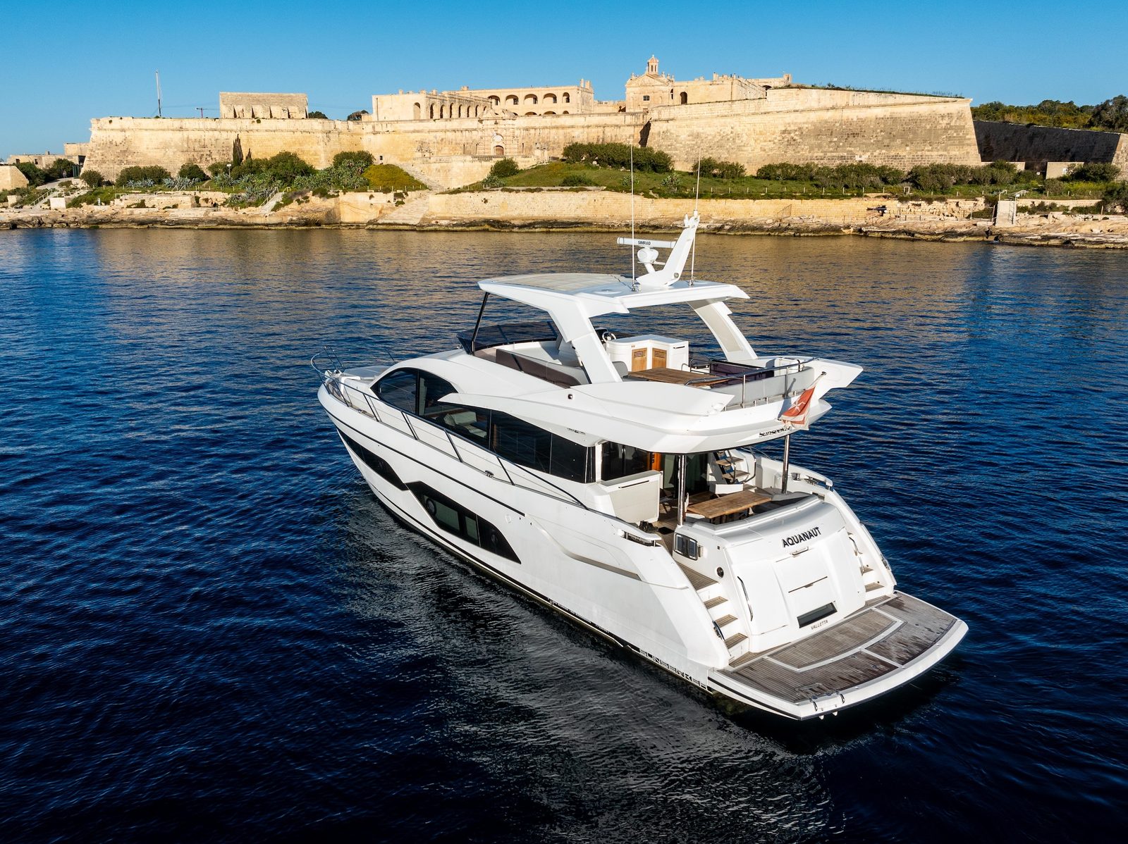 Sunseeker Manhattan 66 AQUANAUT cruising past the Valletta bastions, Malta
